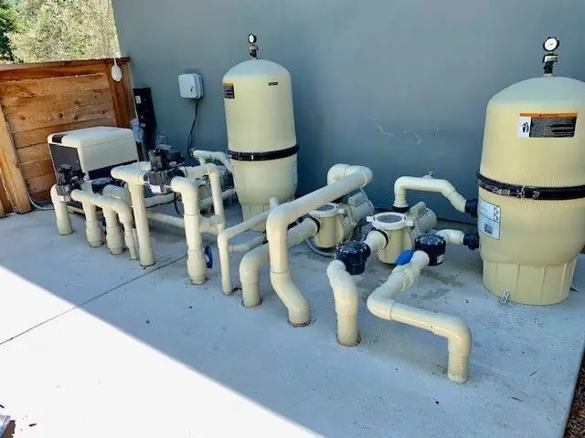 Pool pump, filters and plumbing on an equipment pad